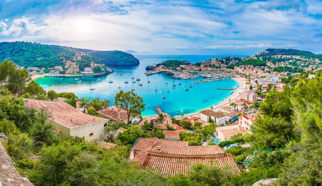 Panoramic view of Porte de Soller, Palma Mallorca, Spain - Coastal view of Mallorca Spain with cliffs, turquoise sea, and terracotta rooftops