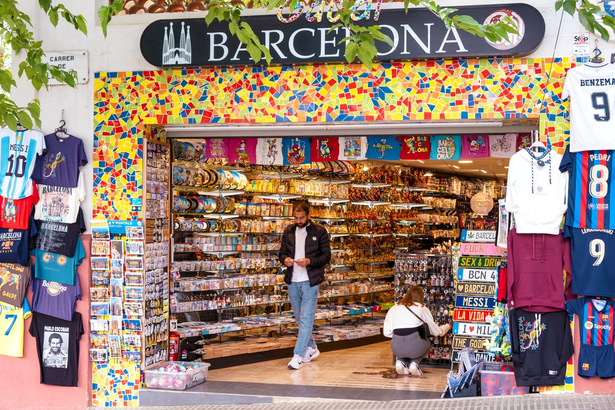 Barcelona, Spain - Traditional souvenir shop in Barcelona, Spain with tourists looking for gifts