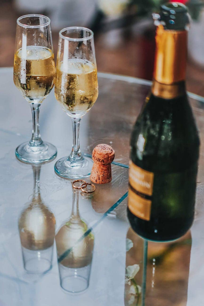 open champagne bottle near two cocktail glasses