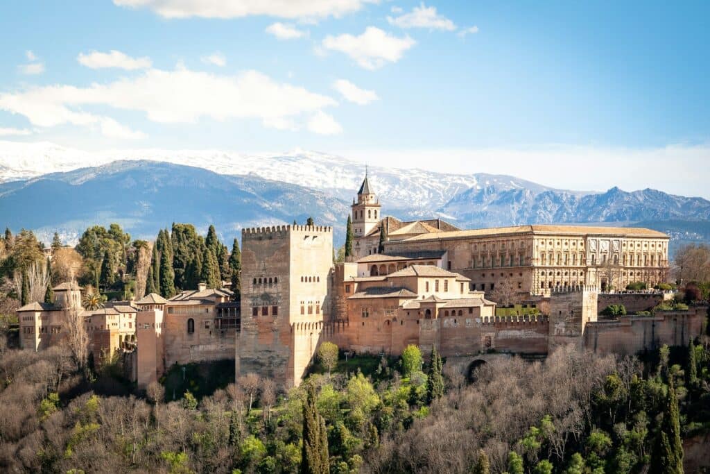 Alhambra palace in spring, Granada, Spain. In early April the mountains are still covered in snow.

